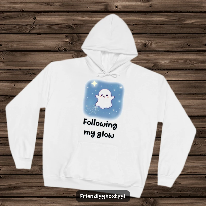 Funny hoodie depicting a gentle ghost leaving a sparkling path through the night sky, a serene and enchanting image.