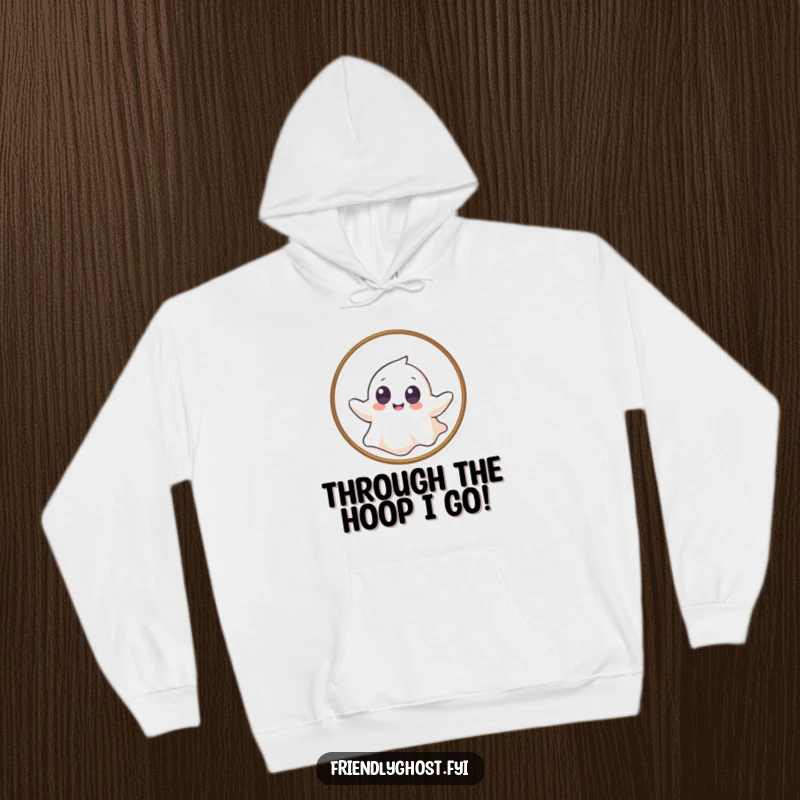 Funny hoodie with a giggling ghost with big eyes gently floating through a hoop, offering cozy and playful vibes.