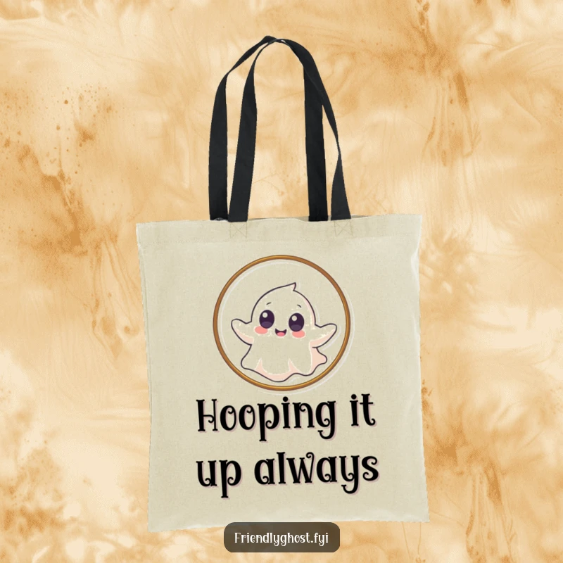 Funny tote bag showing a giggling ghost with big eyes gently floating through a hoop, perfect for carrying essentials with flair.